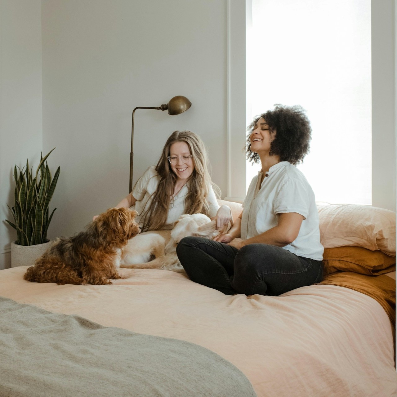 two-girls-on-bed-with-dog